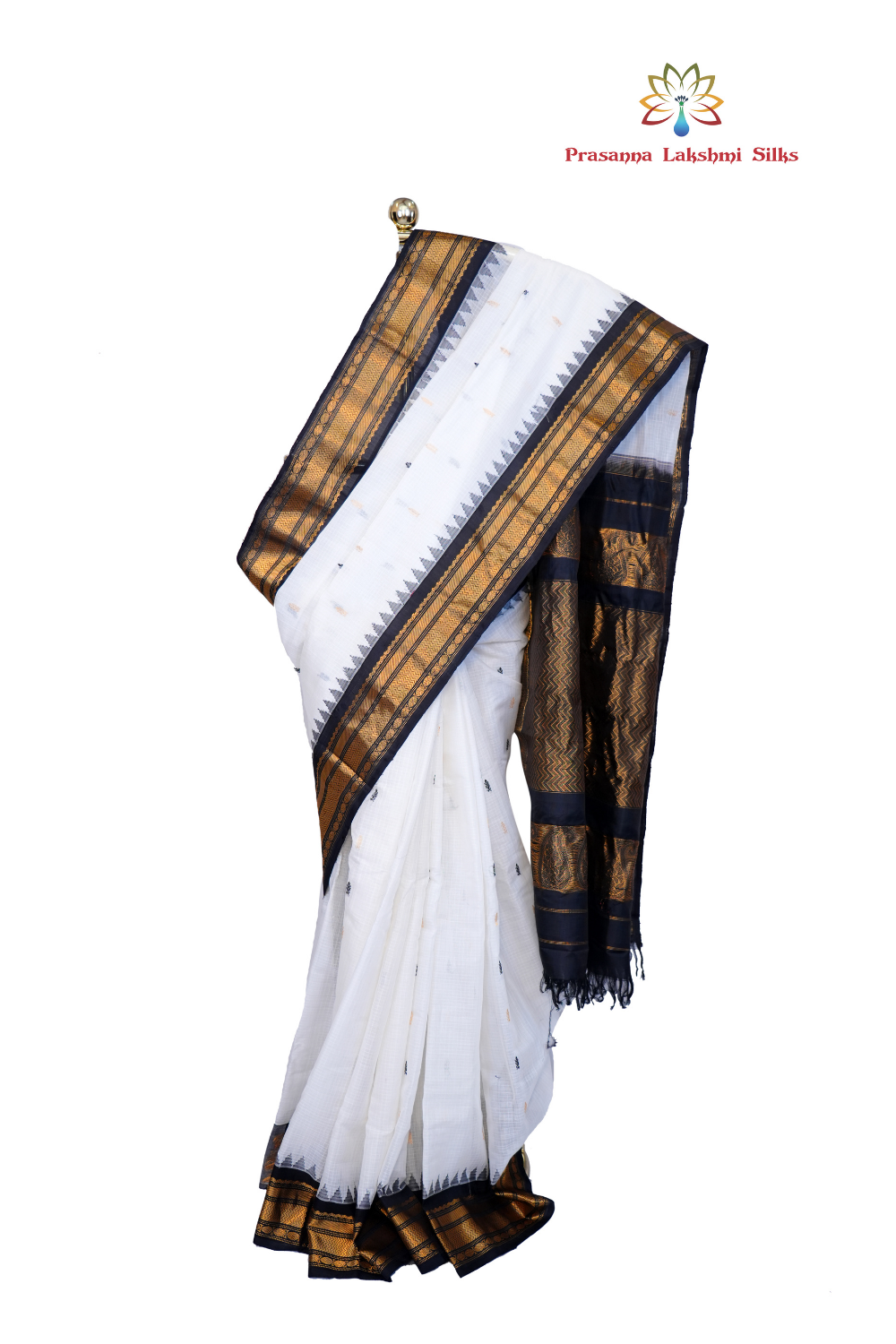 Handloom Gadwal silk cotton saree with all-over zari buttis and rich brocade pallu.
