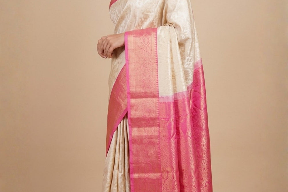 Half white pure handloom Gadwal silk saree with baby pink turning border and all-over gold zari brocade design
