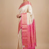 Half white pure handloom Gadwal silk saree with baby pink turning border and all-over gold zari brocade design