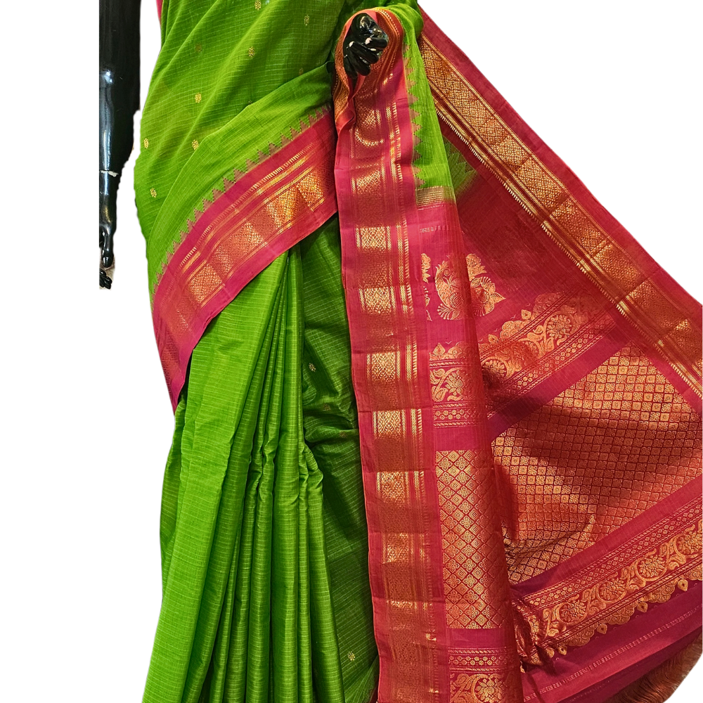 Handloom Gadwal silk cotton saree with all-over zari buttis and rich brocade pallu.
