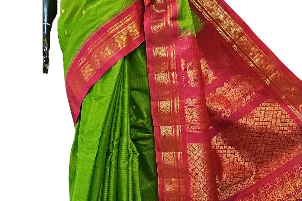 Handloom Gadwal silk cotton saree with all-over zari buttis and rich brocade pallu.
