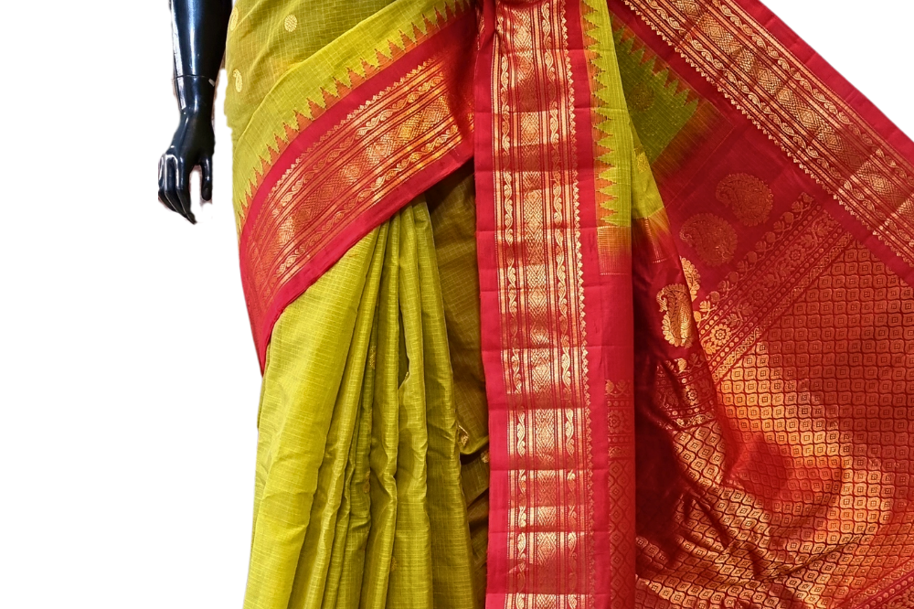 Handloom Gadwal silk cotton saree with all-over zari buttis and rich brocade pallu.
