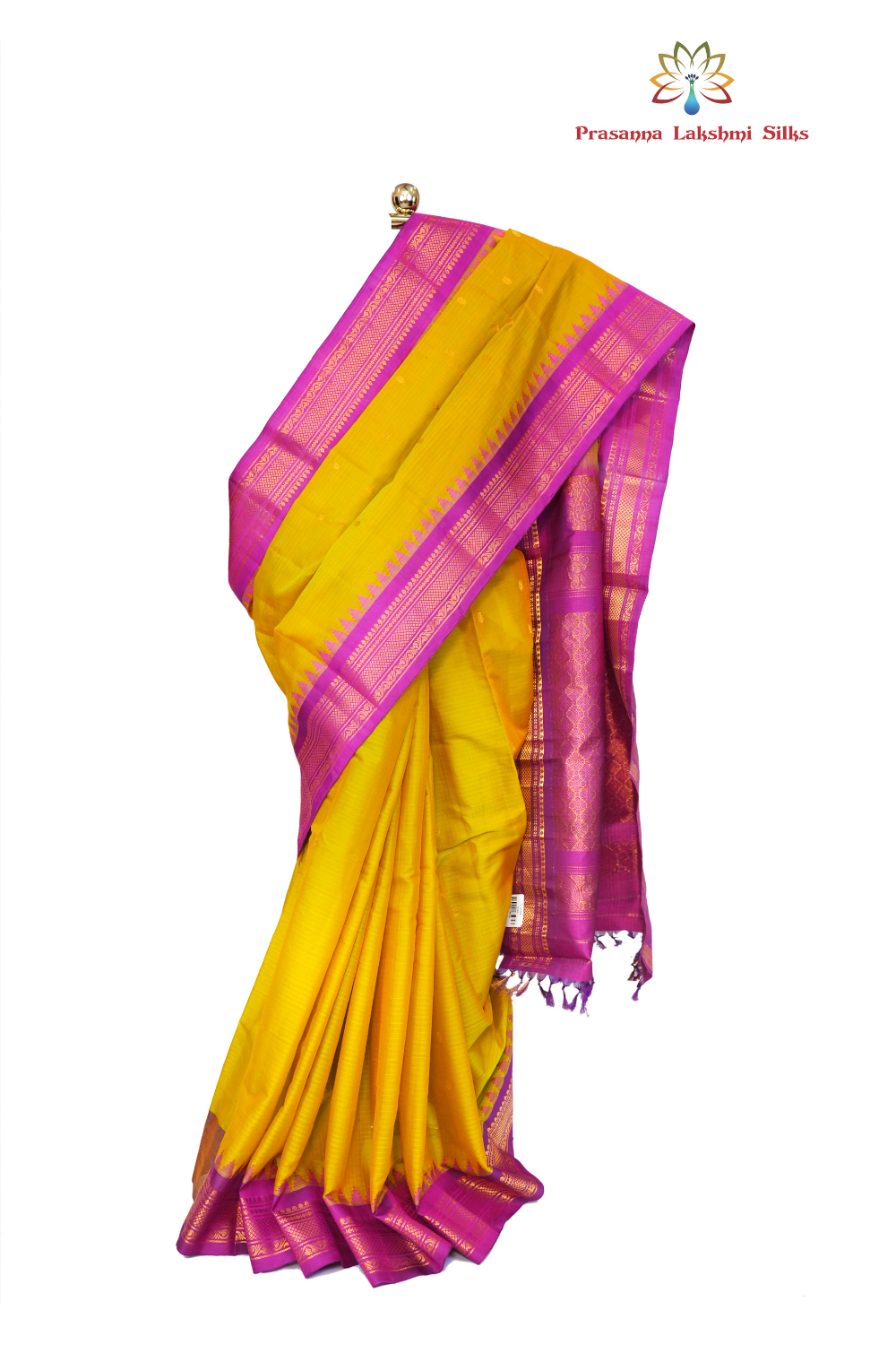 Handloom Gadwal silk cotton saree with all-over zari buttis and rich brocade pallu.
