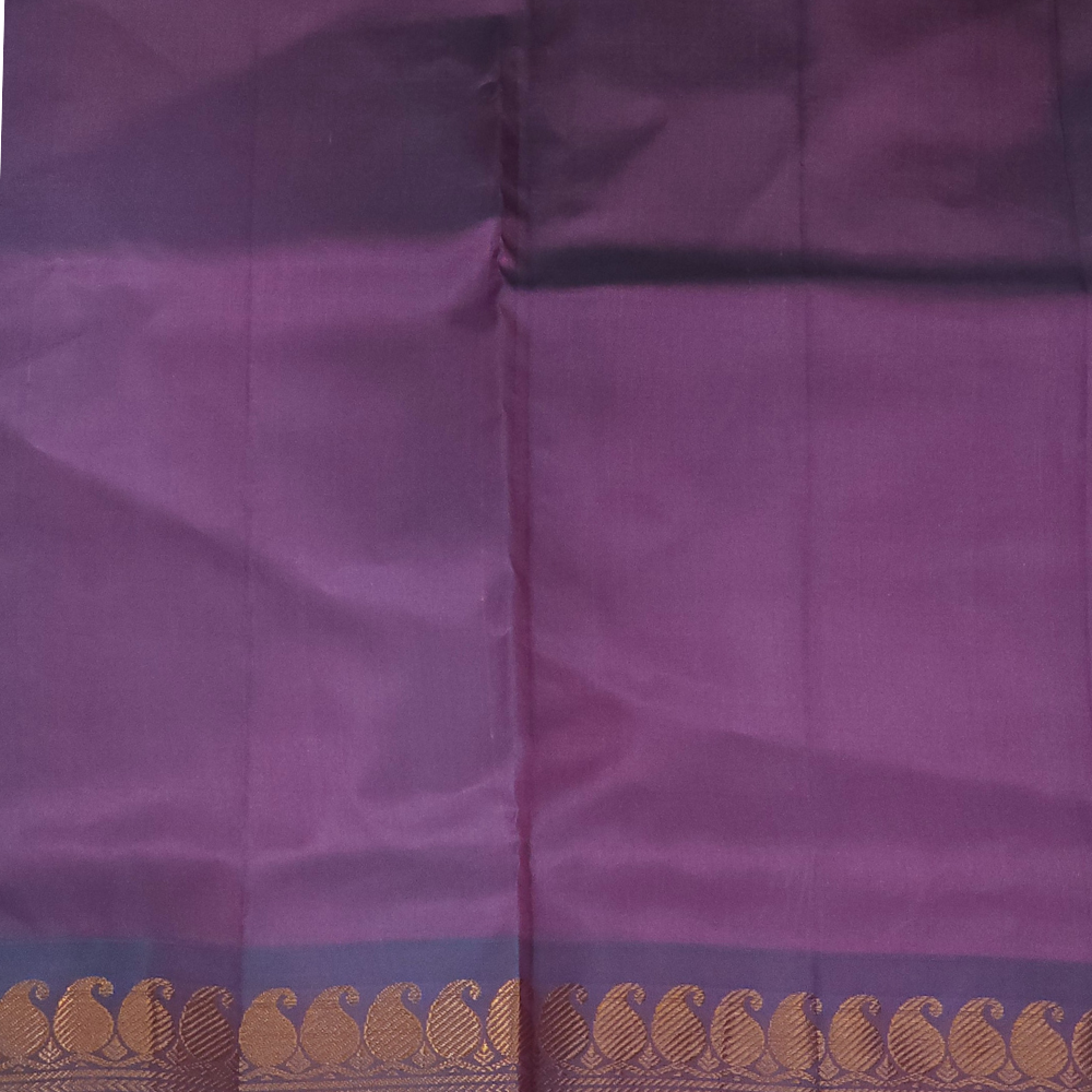Purple fabric with a decorative border featuring gold patterns.