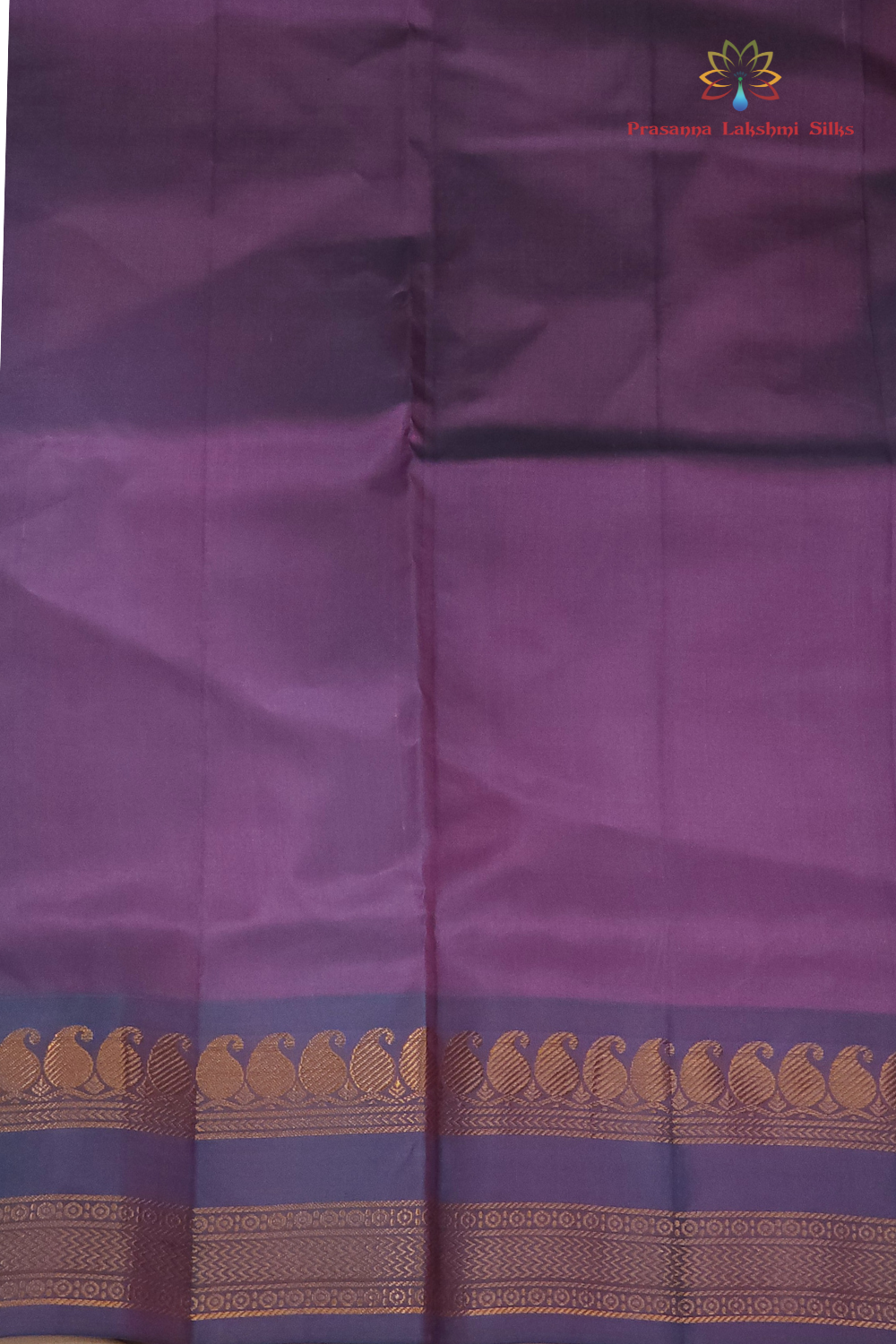 Purple fabric with a decorative border featuring gold patterns.