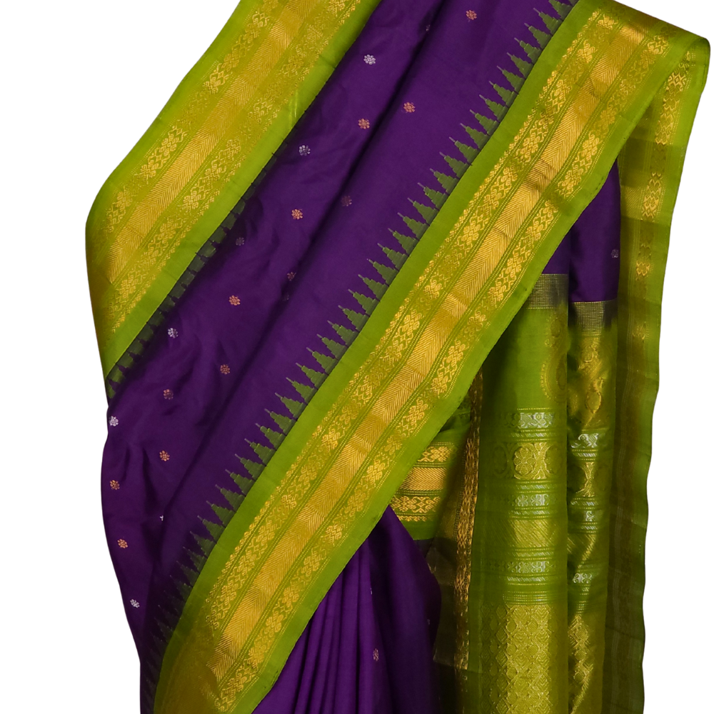 Model draping a Silk Mark certified violet and olive green Gadwal silk saree, highlighting the luxurious texture and elegant contrast blouse.