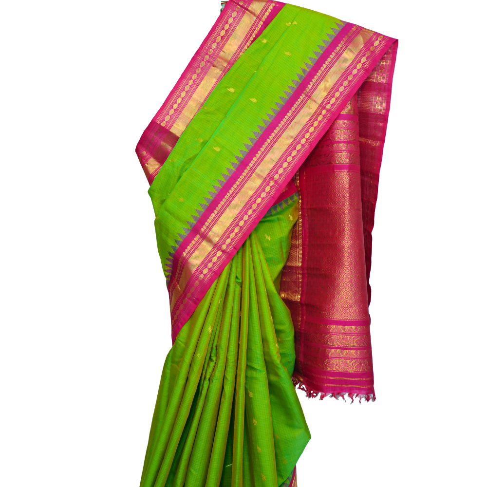 Handloom Gadwal silk cotton saree with all-over zari buttis and rich brocade pallu.
