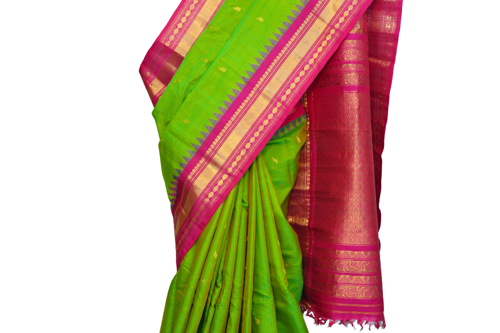 Handloom Gadwal silk cotton saree with all-over zari buttis and rich brocade pallu.
