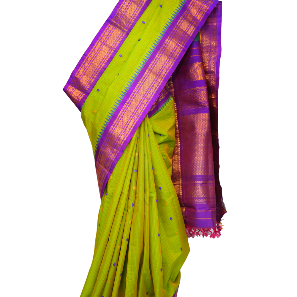 Handloom Gadwal silk cotton saree with all-over zari buttis and rich brocade pallu.
