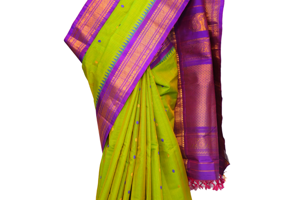 Handloom Gadwal silk cotton saree with all-over zari buttis and rich brocade pallu.
