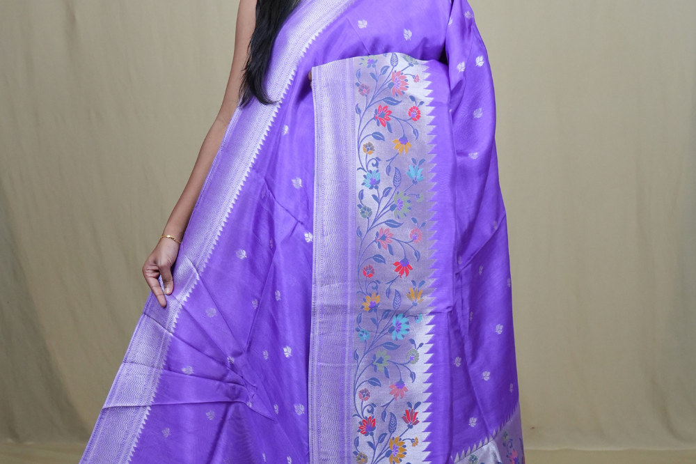 Tussar Georgette Saree with all-over silver zari woven motifs and floral Meenakari borders.
