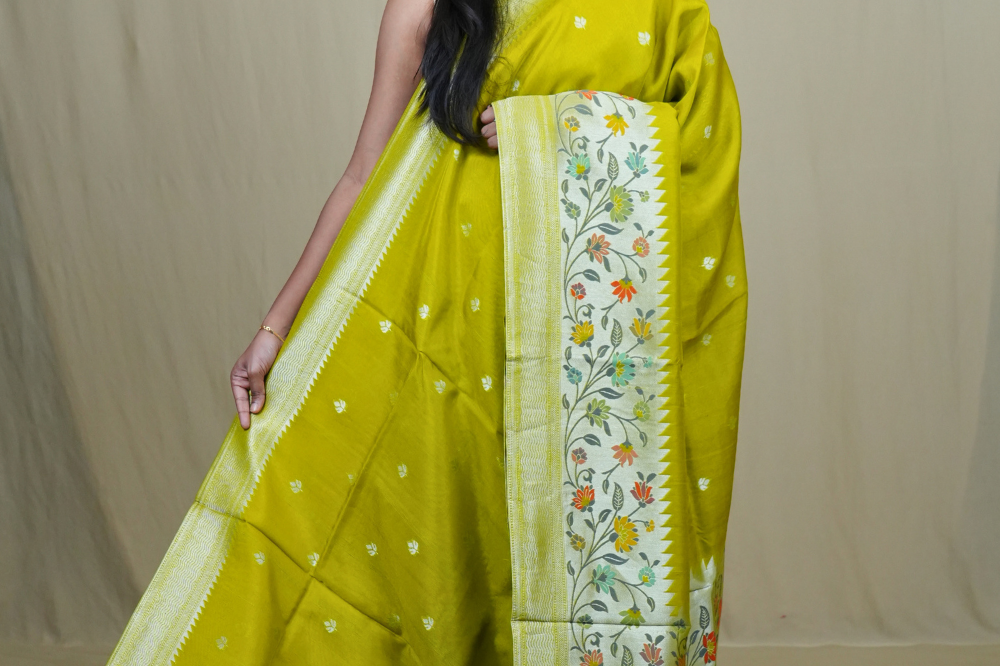 Tussar Georgette Saree with all-over silver zari woven motifs and floral Meenakari borders.
