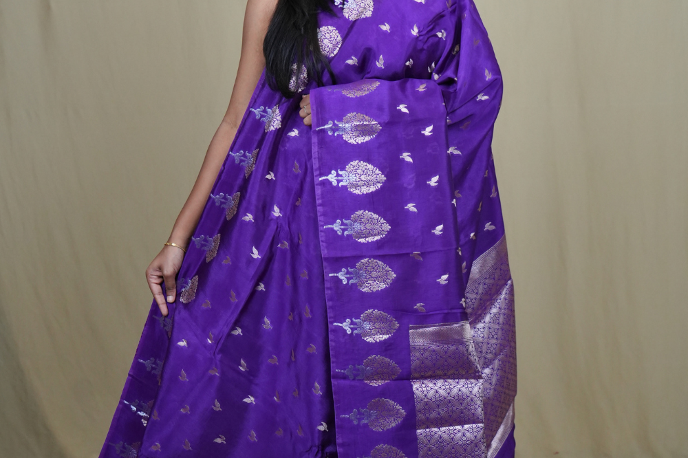 Banarasi Munga silk saree with all-over leaf-shaped zari woven motifs and gold/silver floral borders.
