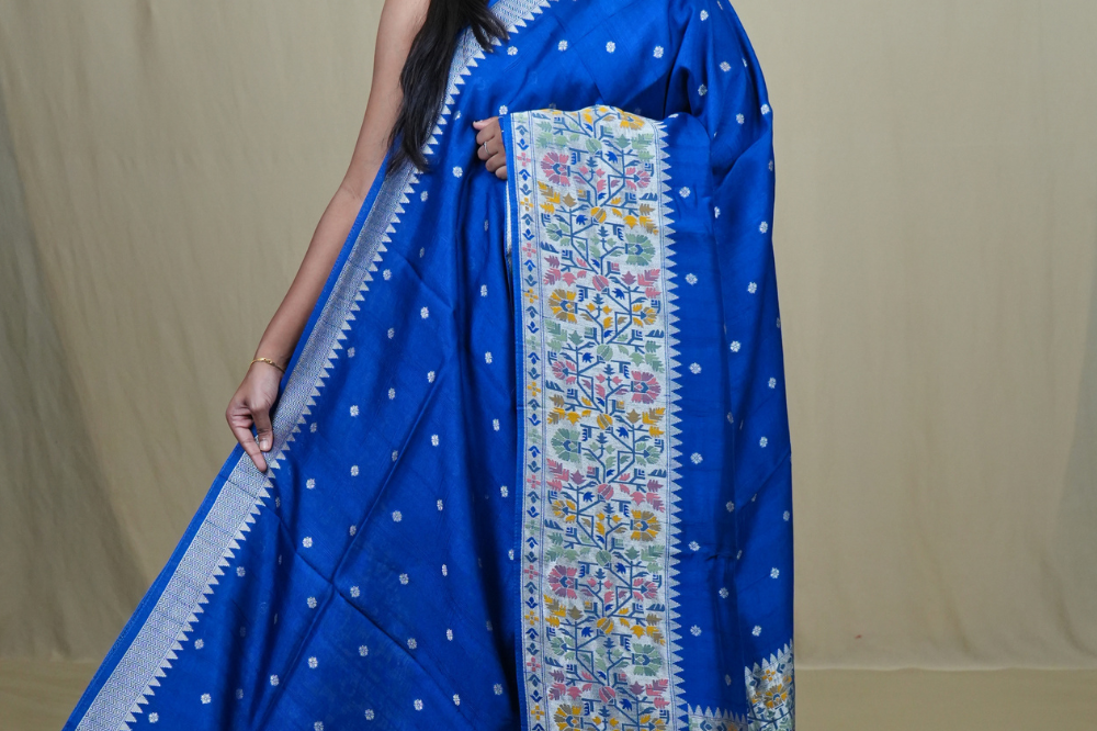 Tussar Georgette Saree with all-over silver zari woven motifs and floral Meenakari borders.
