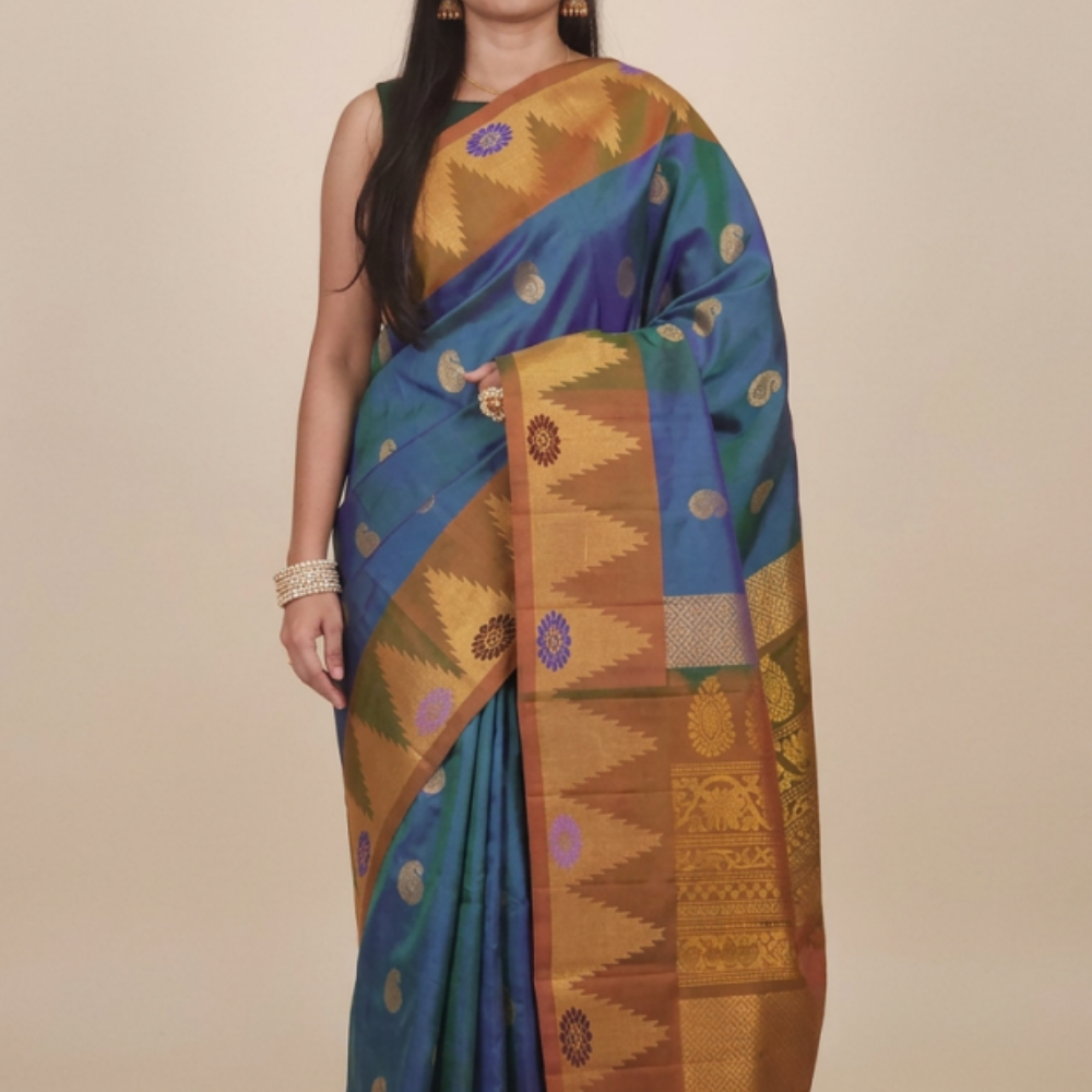 Gadwal Silk Saree featuring all-over zari motifs, intricate meenakari border, rich zari brocade pallu, and contrast blouse.
