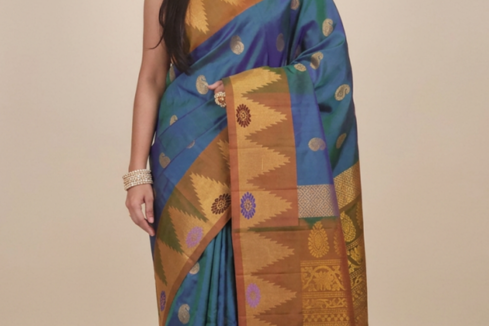 Gadwal Silk Saree featuring all-over zari motifs, intricate meenakari border, rich zari brocade pallu, and contrast blouse.
