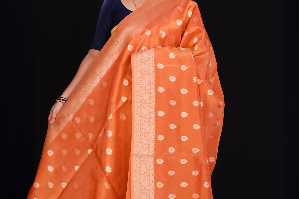 Orange Subtle munga tissue saree in pastel tones