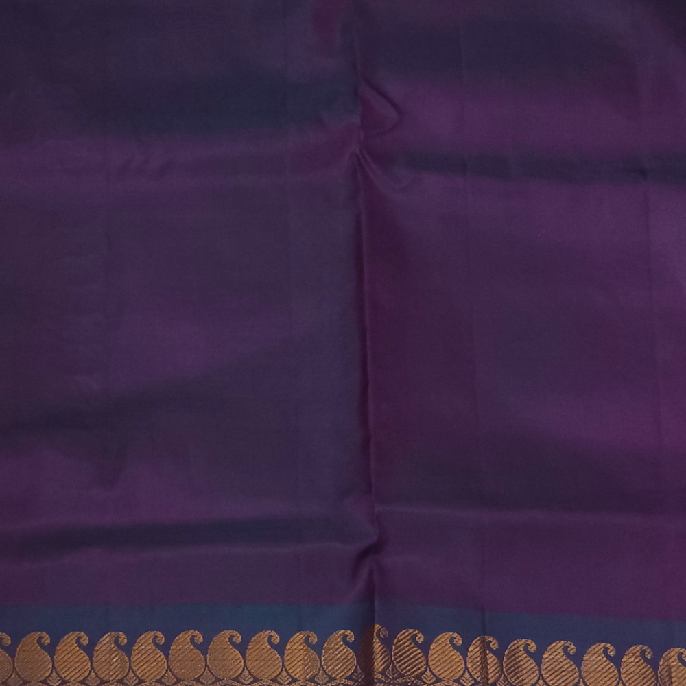 Purple saree with a decorative border featuring a brand logo in the corner.