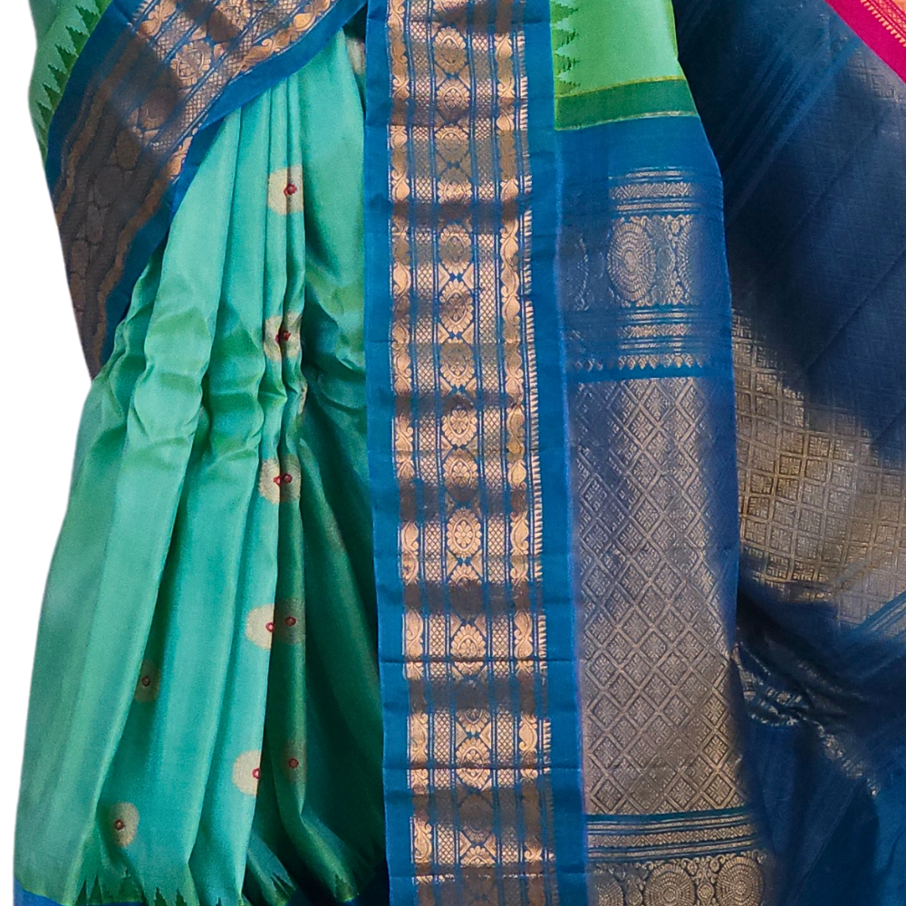 Premium Silk Mark certified sea green Gadwal saree paired with a matching teal blue blouse, showcasing the luxurious drape and dual-colored border design.