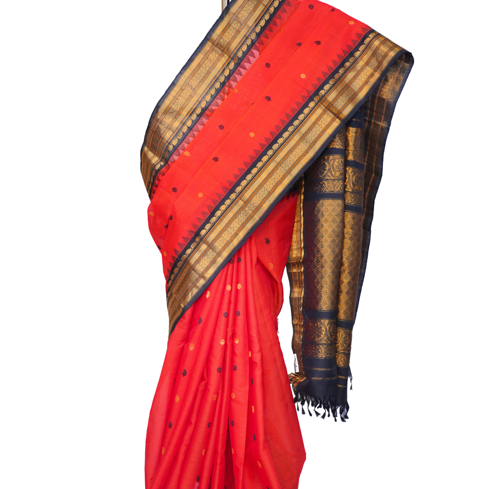 Handloom Gadwal silk cotton saree with all-over zari buttis and rich brocade pallu.
