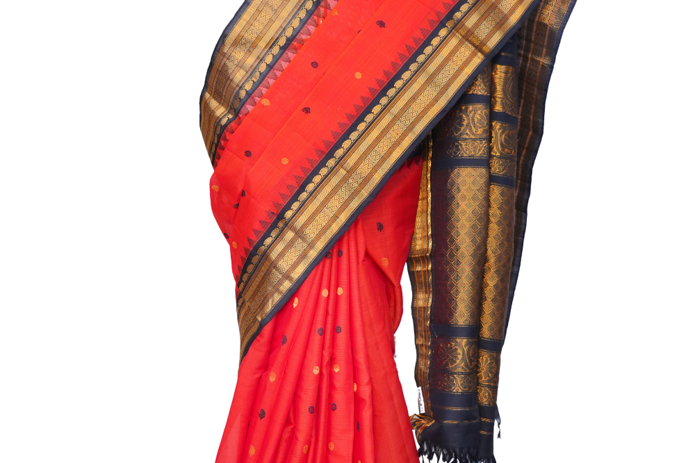 Handloom Gadwal silk cotton saree with all-over zari buttis and rich brocade pallu.
