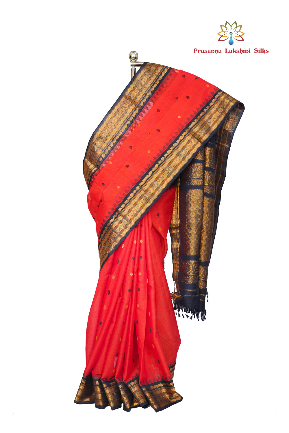Handloom Gadwal silk cotton saree with all-over zari buttis and rich brocade pallu.
