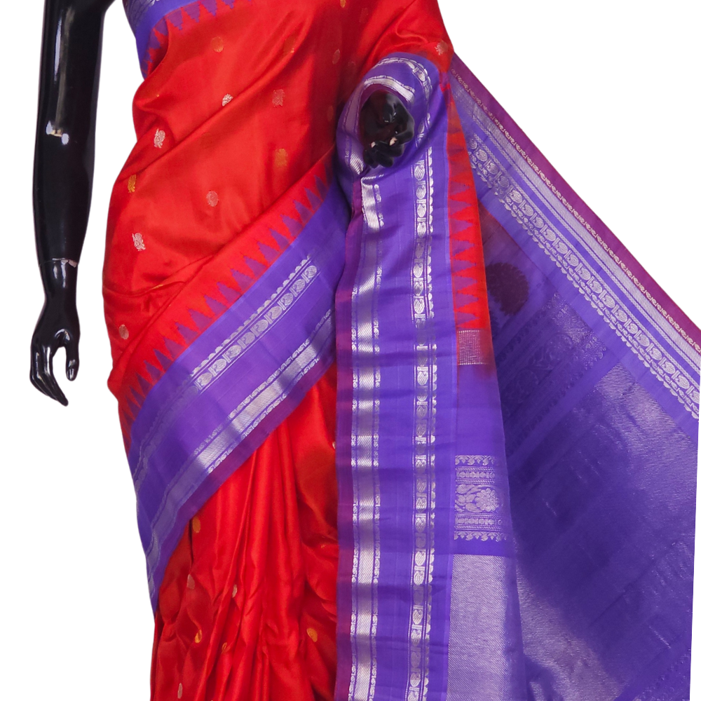 Silk Mark certified Gadwal silk saree in dark orange with lavender blouse and intricate zari motifs