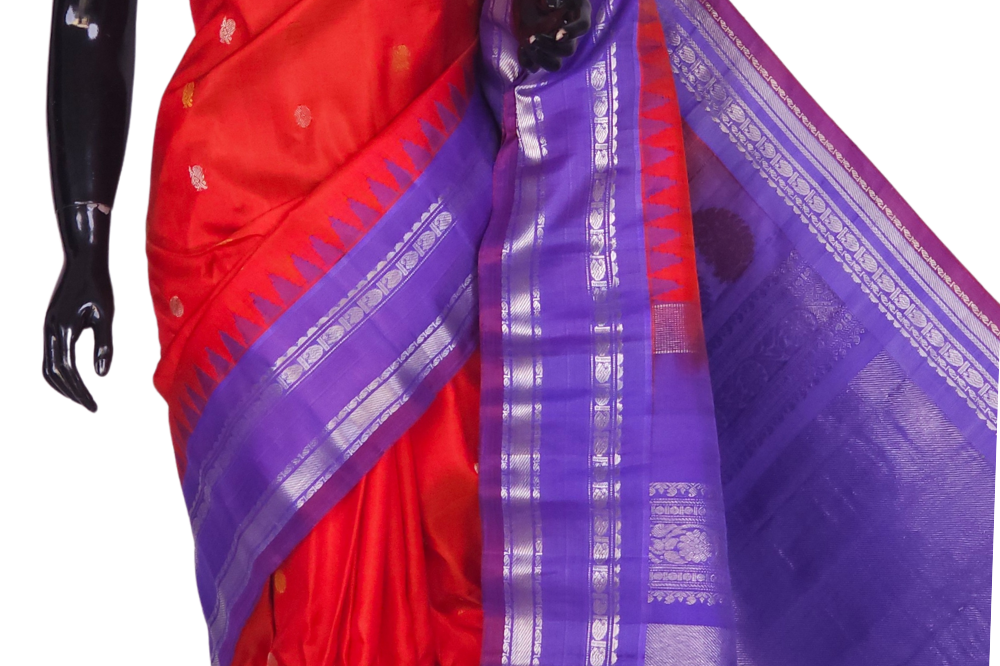Silk Mark certified Gadwal silk saree in dark orange with lavender blouse and intricate zari motifs