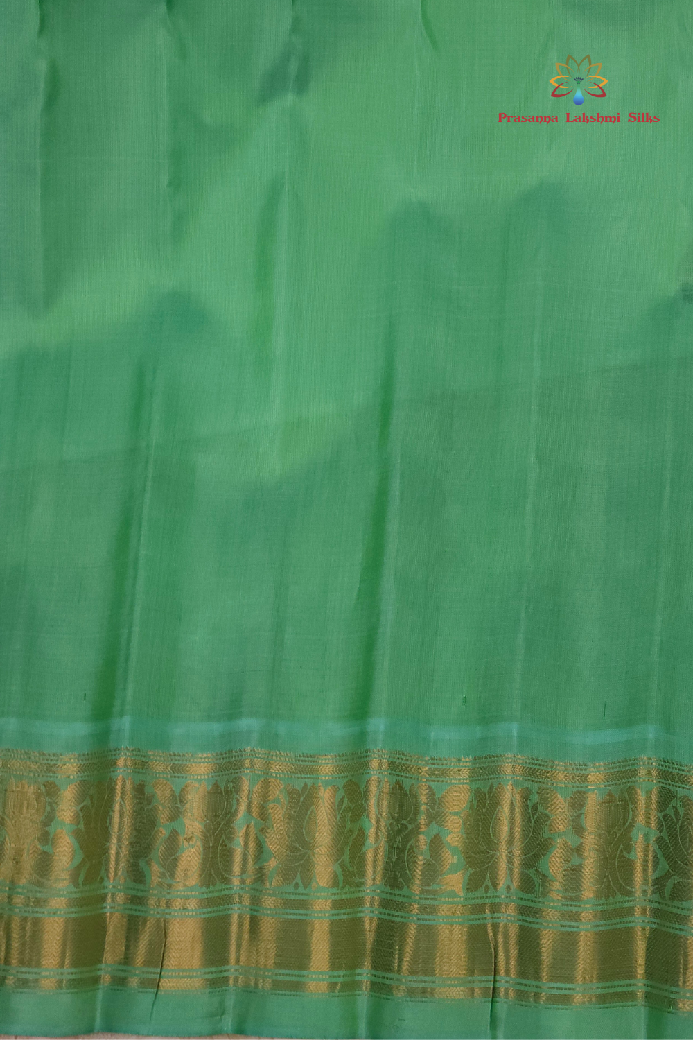 Silk Mark certified navy blue Gadwal silk saree with contrast Sea Green border and intricate zari motifs

