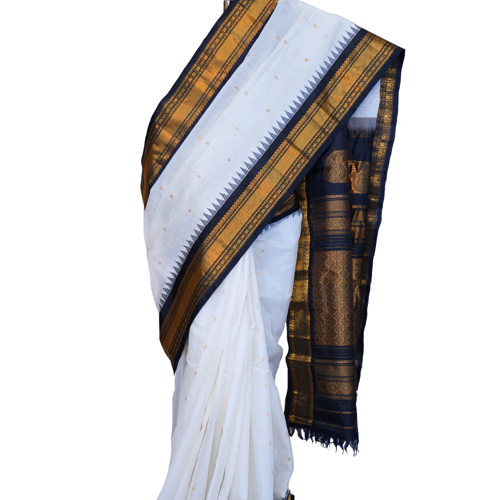 Handloom Gadwal silk cotton saree with all-over zari buttis and rich brocade pallu.
