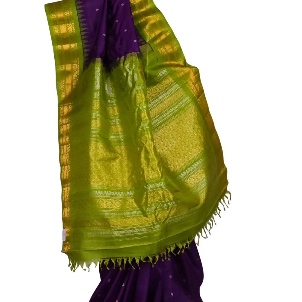 Close-up shot of the rich zari-woven brocade pallu on a handloom violet Gadwal pure silk saree, showcasing the detailed craftsmanship.